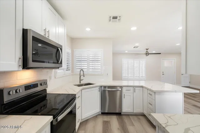 a kitchen with a sink stove and microwave