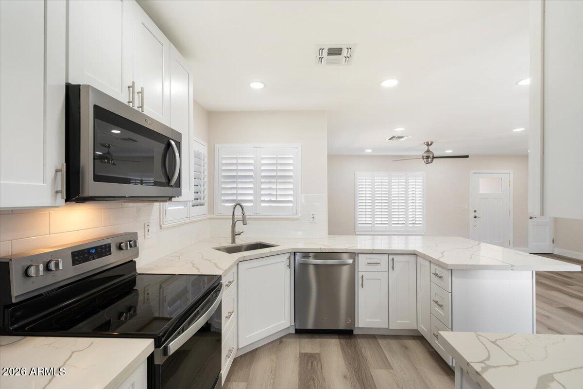 Undisclosed Address Phoenix, AZ 85013 - Photo 5 of 16 a kitchen with a sink stove and microwave
