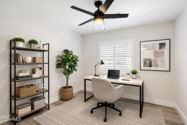 a workspace with furniture and a potted plant