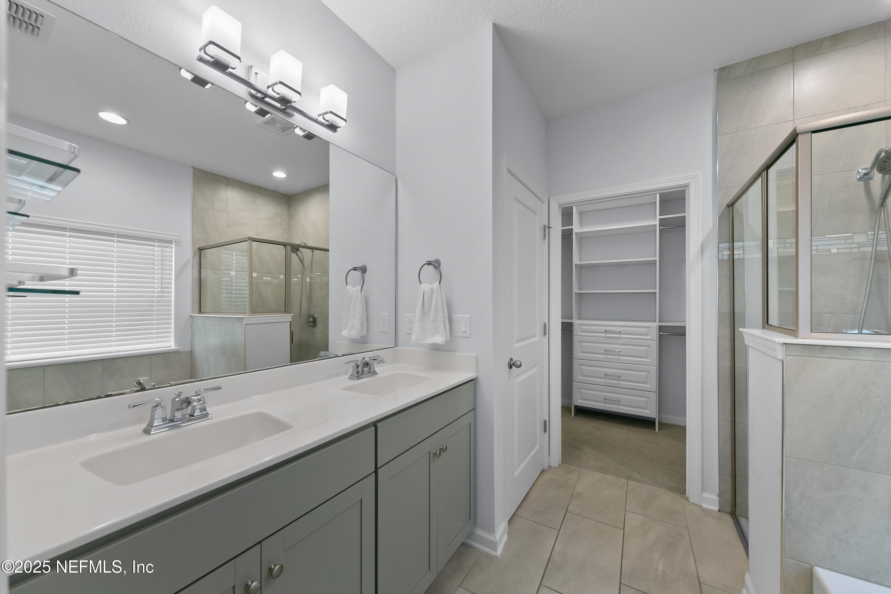 247 Beale Avenue St. Augustine, FL 32092 - Photo 16 of 62 a spacious bathroom with a double vanity sink a mirror and shower