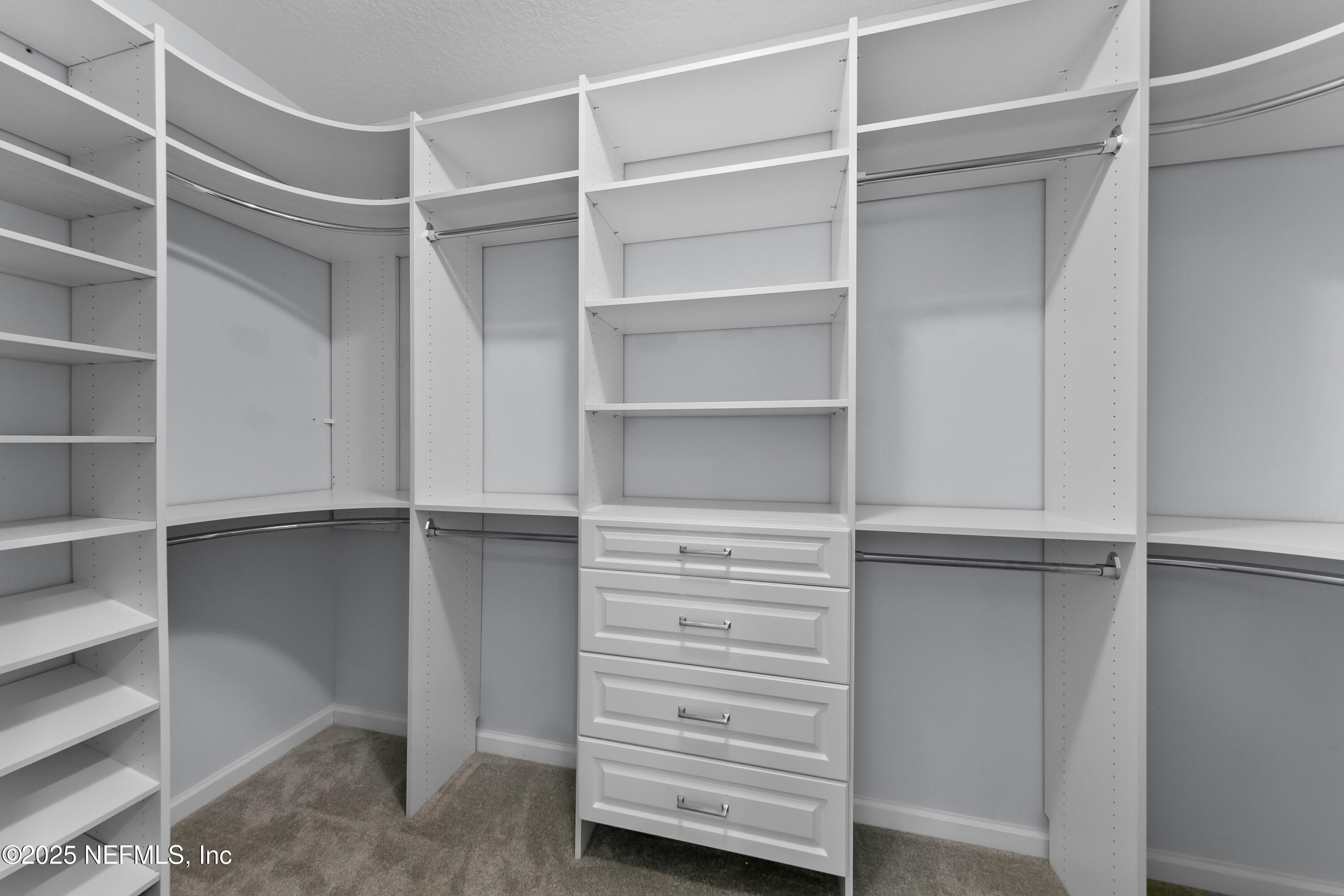 247 Beale Avenue St. Augustine, FL 32092 - Photo 17 of 62 a view of walk in closet with empty racks