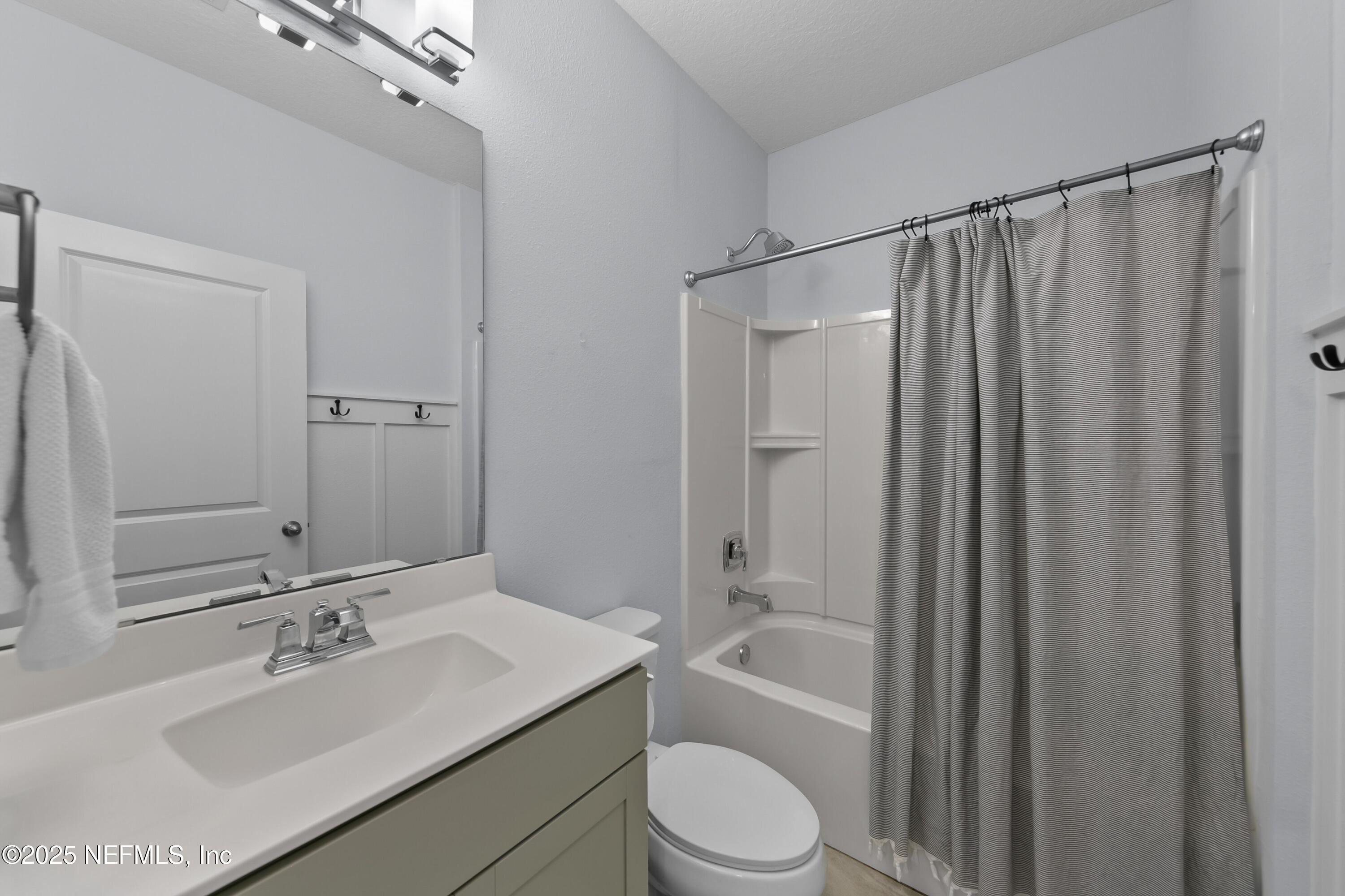 247 Beale Avenue St. Augustine, FL 32092 - Photo 20 of 62 a bathroom with a sink a toilet a mirror and shower