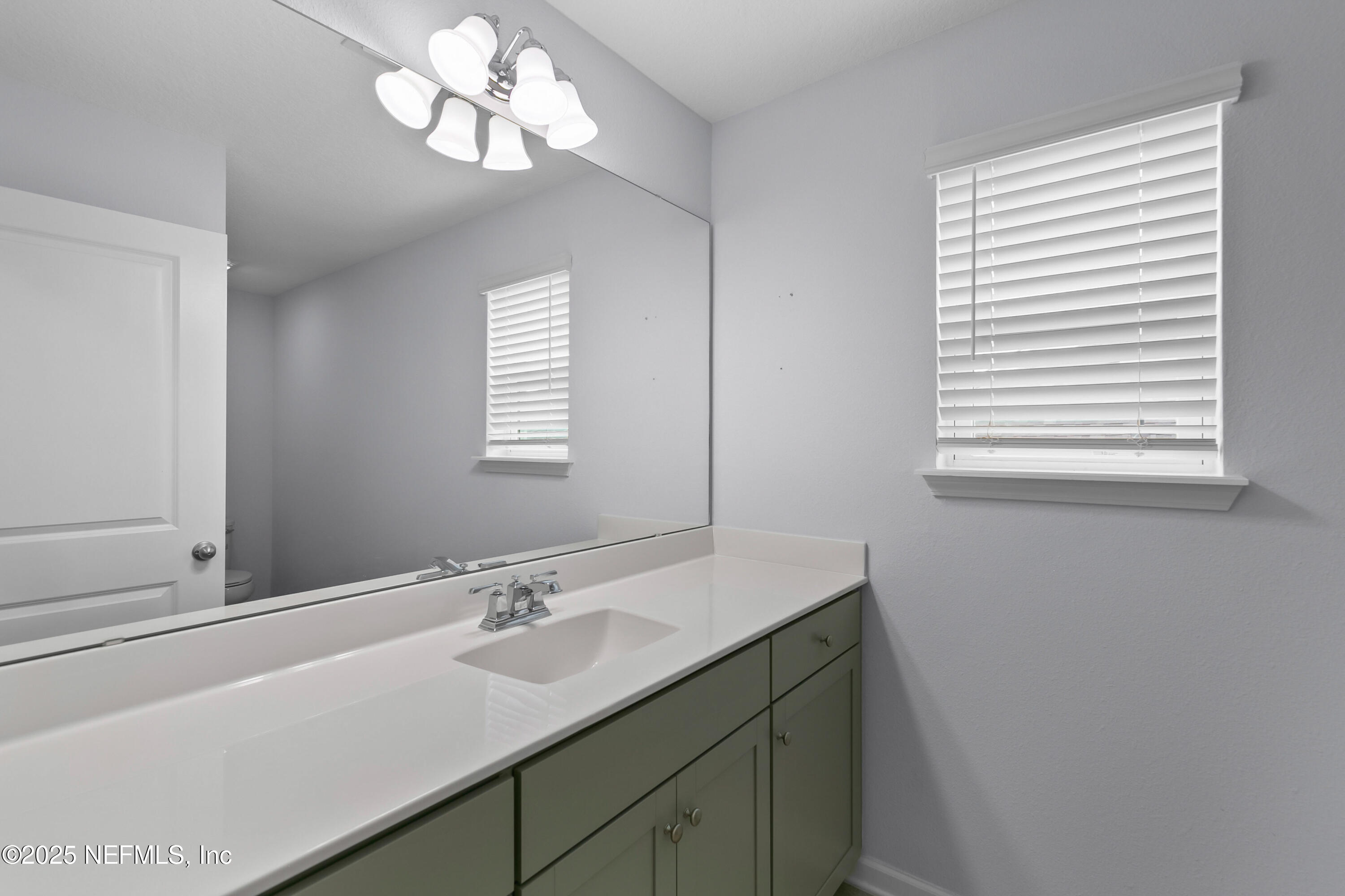 247 Beale Avenue St. Augustine, FL 32092 - Photo 25 of 62 a bathroom with a sink and a mirror