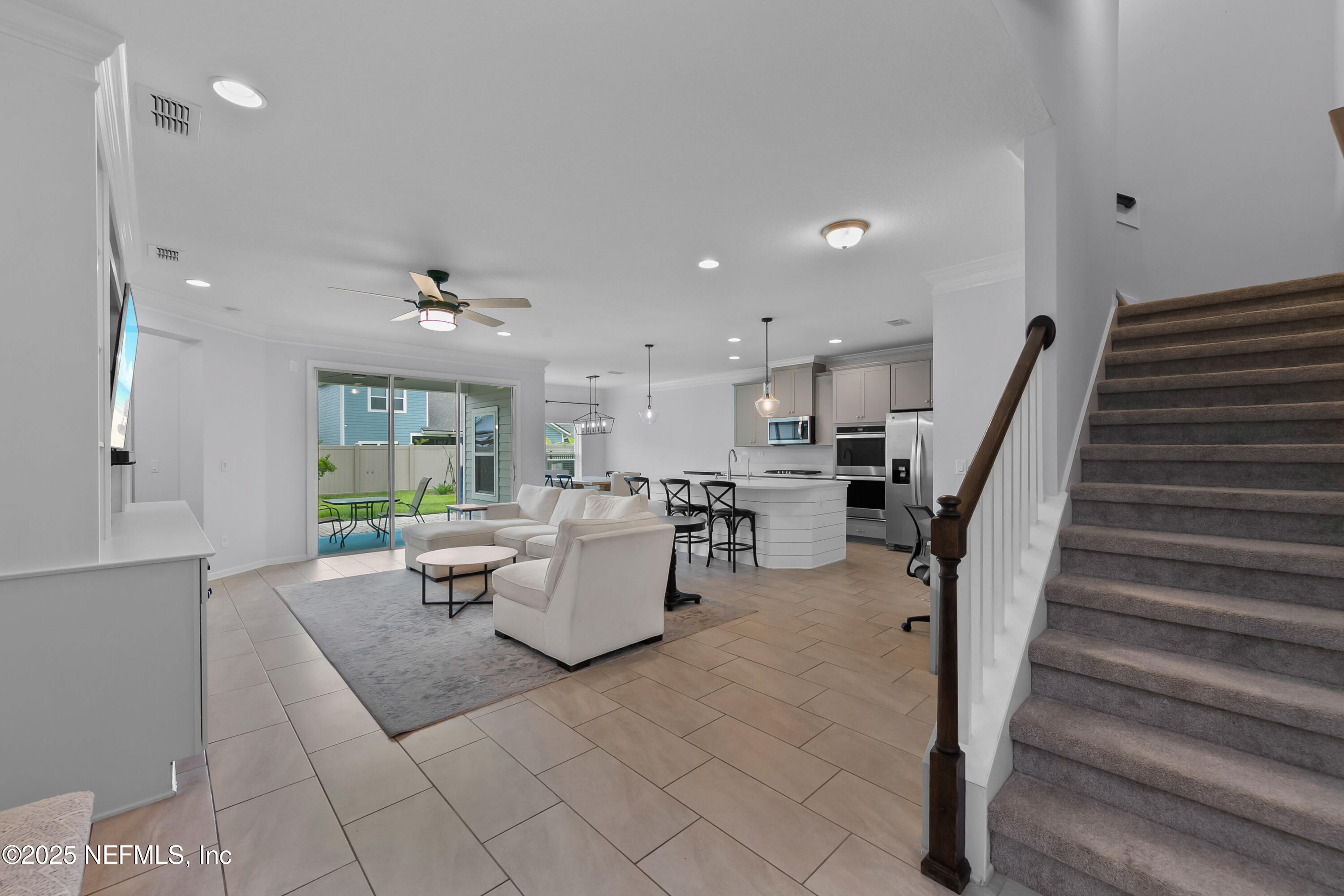 247 Beale Avenue St. Augustine, FL 32092 - Photo 4 of 62 a living room with couches and kitchen view with wooden floor