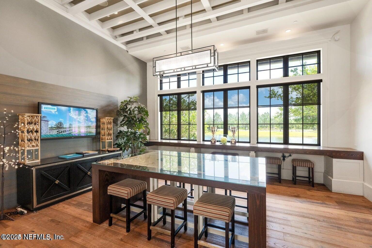 247 Beale Avenue St. Augustine, FL 32092 - Photo 46 of 62 a view of a dining room with furniture large windows and wooden floor