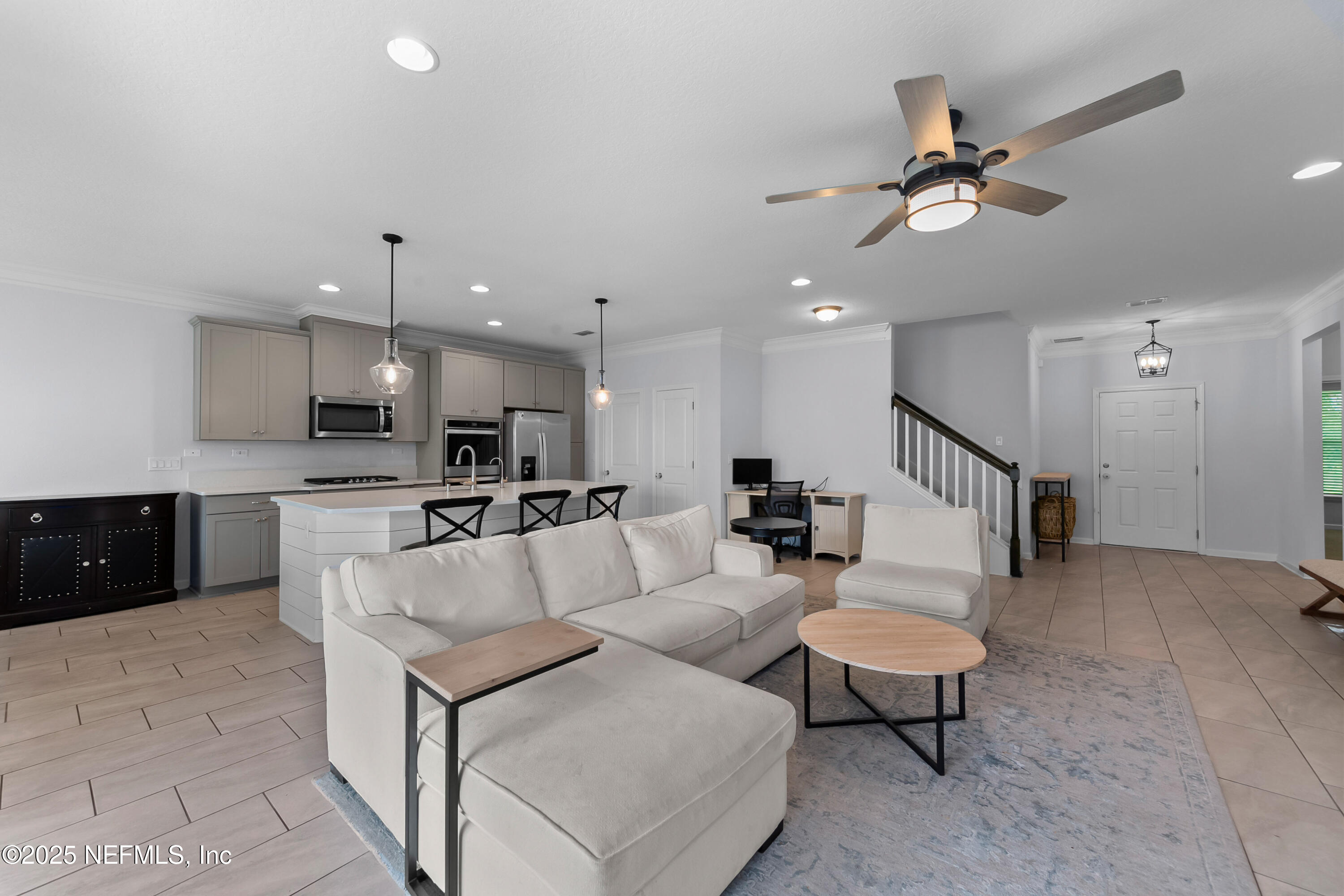 247 Beale Avenue St. Augustine, FL 32092 - Photo 6 of 62 a living room with furniture kitchen view and a chandelier