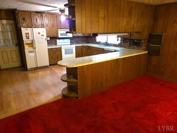 a kitchen with refrigerator and window
