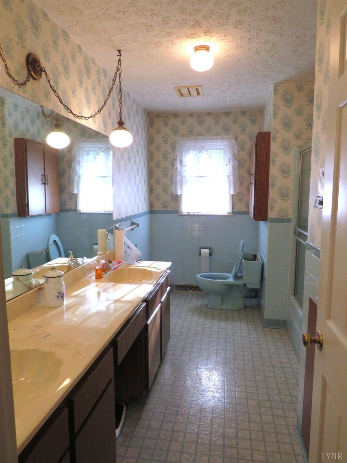 11420 Wards Road Rustburg, VA 24588 - Photo 19 of 34 a bathroom with a sink a vanity and a mirror