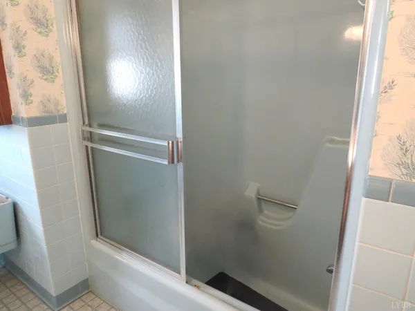a bathroom with a glass door shower
