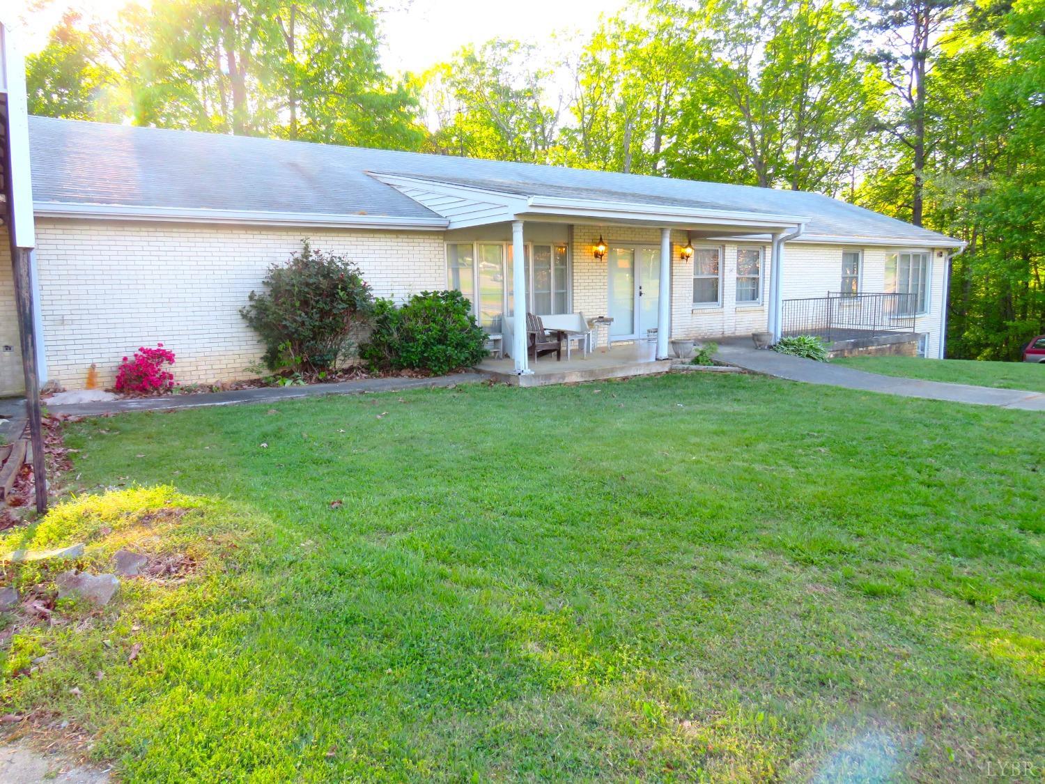 11420 Wards Road Rustburg, VA 24588 - Photo 2 of 34 a view of a house with a backyard and sitting area