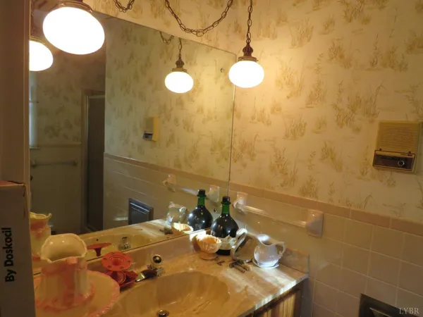 a bathroom with a sink mirror and vanity