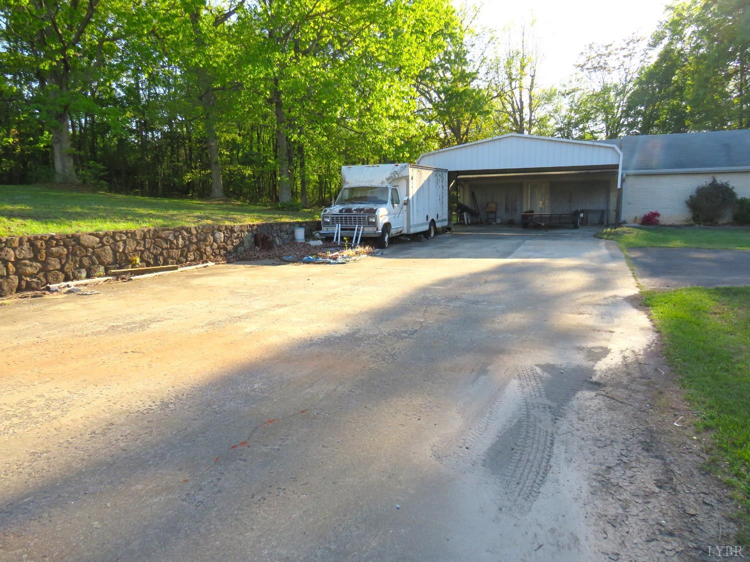 11420 Wards Road Rustburg, VA 24588 - Photo 4 of 34 a house view with a sitting space and garden