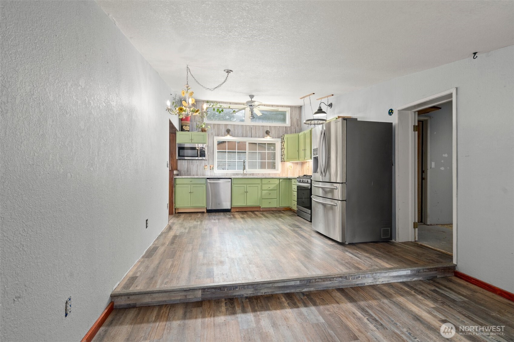 288 Hewitt Road Chehalis, WA 98532 - Photo 9 of 40 a kitchen with refrigerator and wooden floor