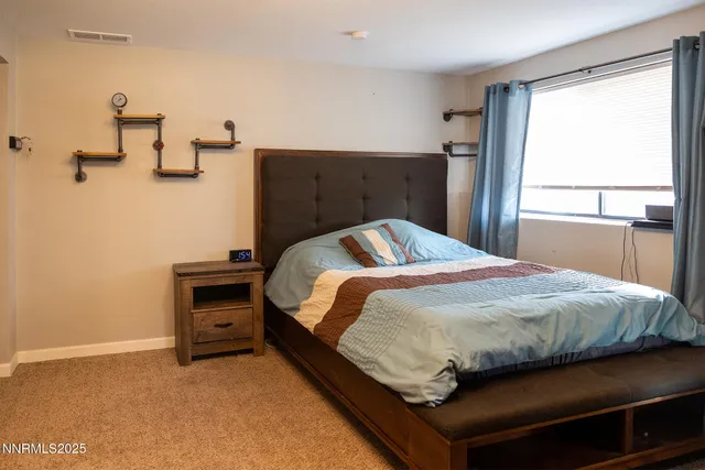 a bedroom with a bed and dresser
