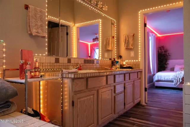 a bathroom with double vanity sinks and a mirror
