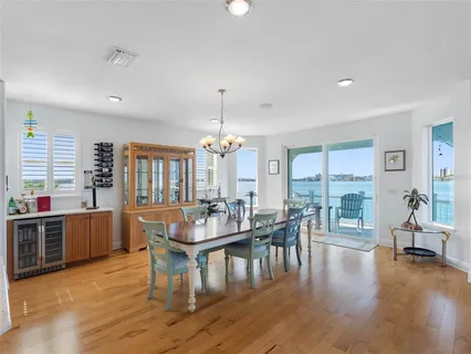 a kitchen with stainless steel appliances granite countertop a sink a stove and a wooden floors
