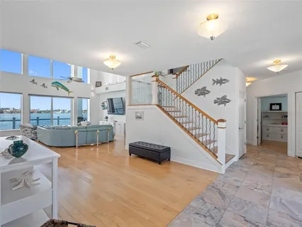 a view of a balcony with wooden floor and outdoor seating