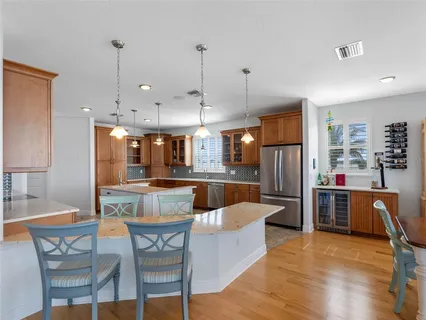 a view of a roof deck with table and chairs and wooden floor