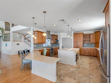 a view of a balcony with chairs and wooden floor