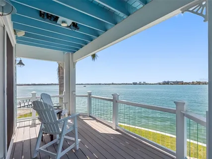a spacious bedroom with a large bed and a chandelier