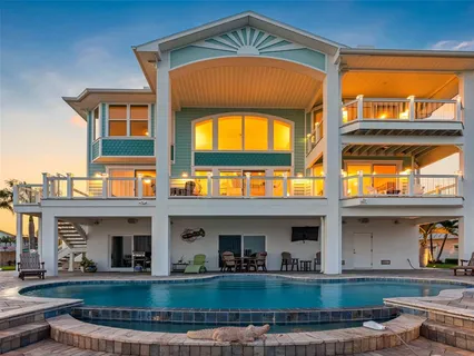 a front view of a house with a garden and plants