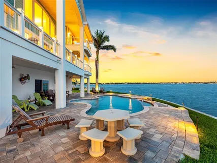 a view of a dining room with furniture a chandelier and wooden floor