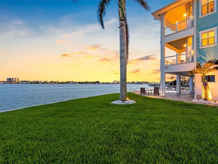a view of a dining room with furniture a chandelier and wooden floor