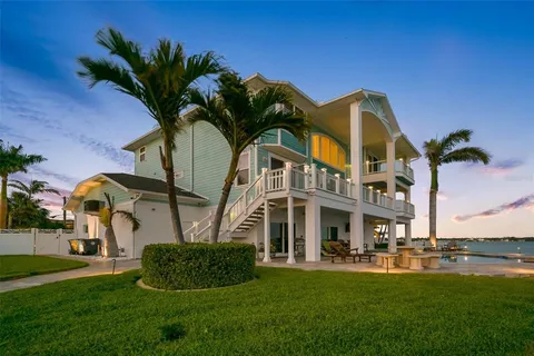 a view of a dining room with furniture a kitchen and chandelier