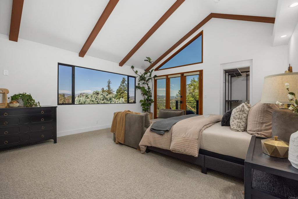 602 Sereno View Road Encinitas, CA 92024 - Photo 12 of 34 a bedroom with a bed and a large window