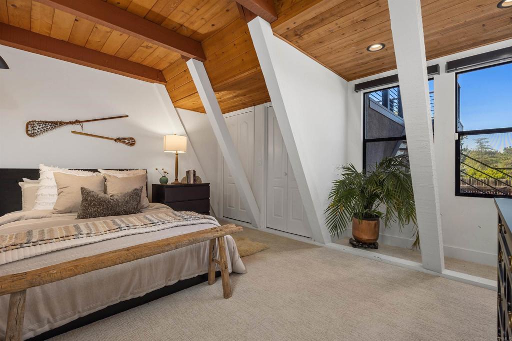 602 Sereno View Road Encinitas, CA 92024 - Photo 19 of 34 a bedroom with a bed and a potted plant