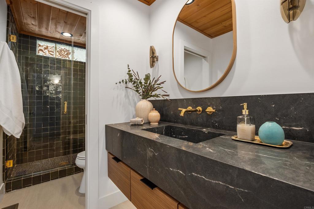 602 Sereno View Road Encinitas, CA 92024 - Photo 20 of 34 a bathroom with a sink and a mirror