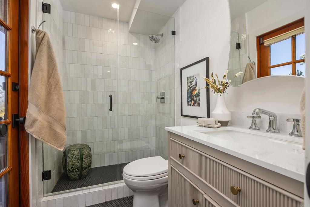 602 Sereno View Road Encinitas, CA 92024 - Photo 22 of 34 a bathroom with a granite countertop sink toilet and shower
