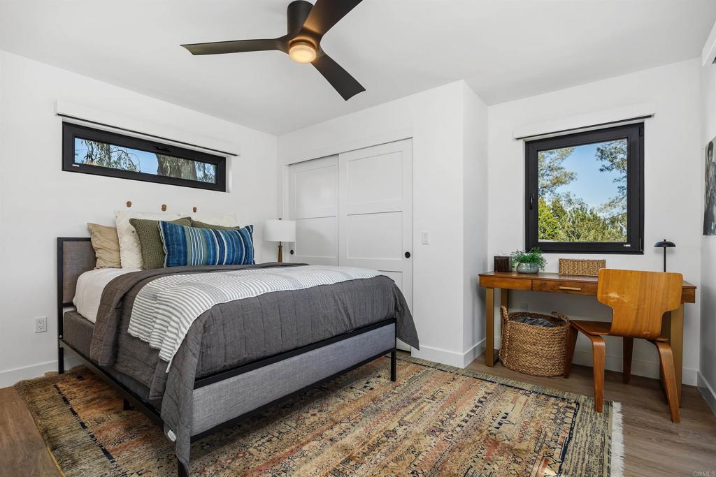 602 Sereno View Road Encinitas, CA 92024 - Photo 29 of 34 a bedroom with a bed and wooden floor