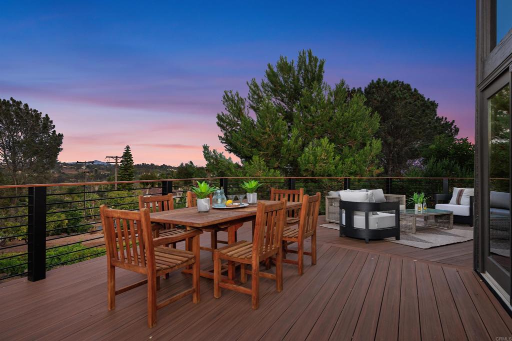 602 Sereno View Road Encinitas, CA 92024 - Photo 33 of 34 a view of a roof deck with table and chairs with wooden floor and fence