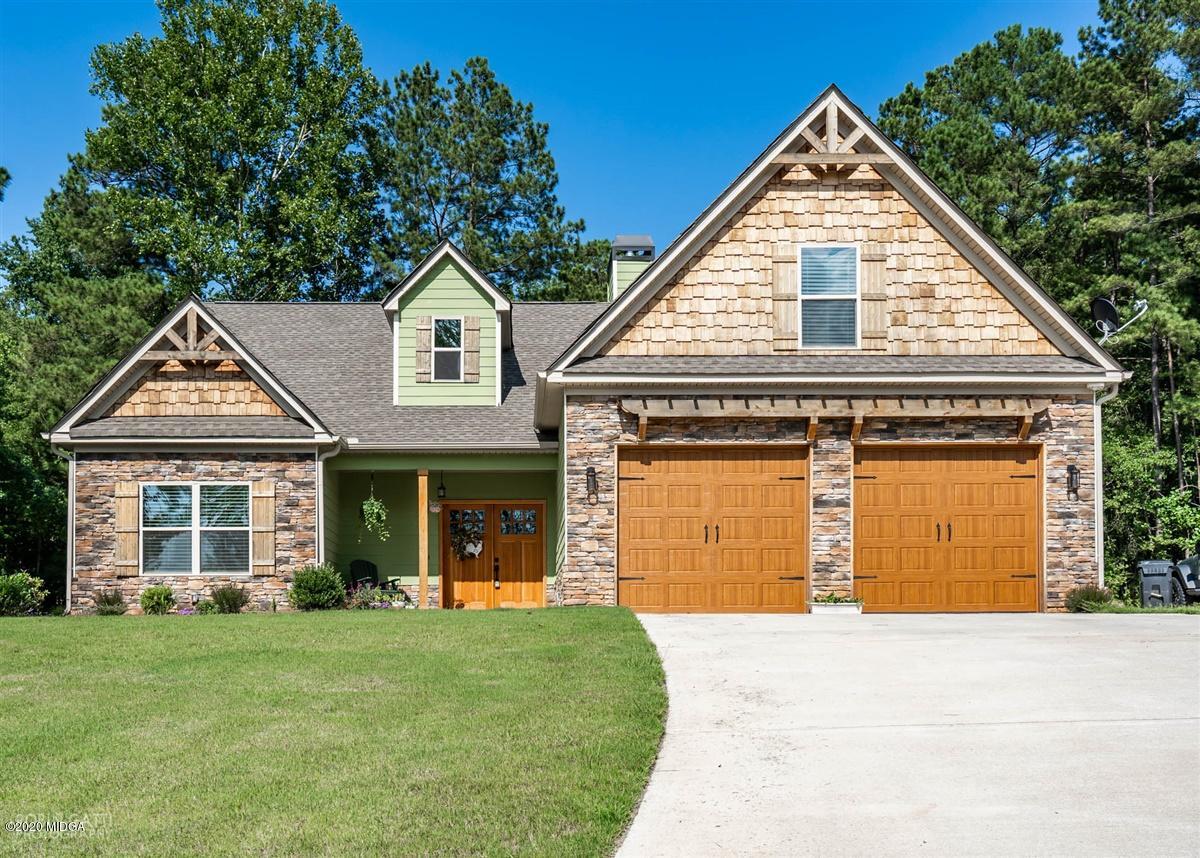 826 Holly Ridge Drive Gray, GA 31032 - Photo 1 of 28 a front view of a house with a garden and garage