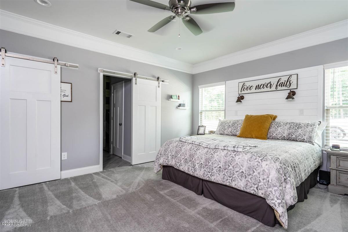 826 Holly Ridge Drive Gray, GA 31032 - Photo 15 of 28 a bedroom with a bed and ceiling fan