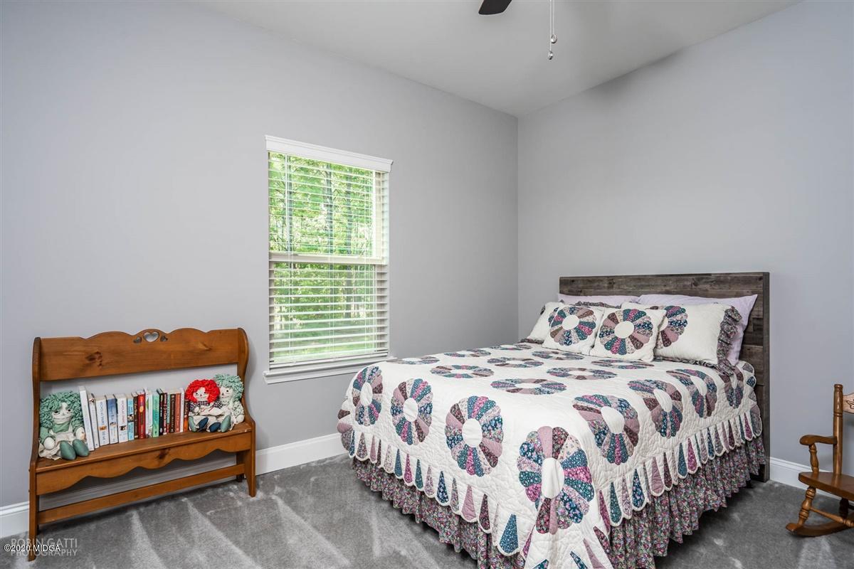 826 Holly Ridge Drive Gray, GA 31032 - Photo 18 of 28 a bedroom with a bed and window