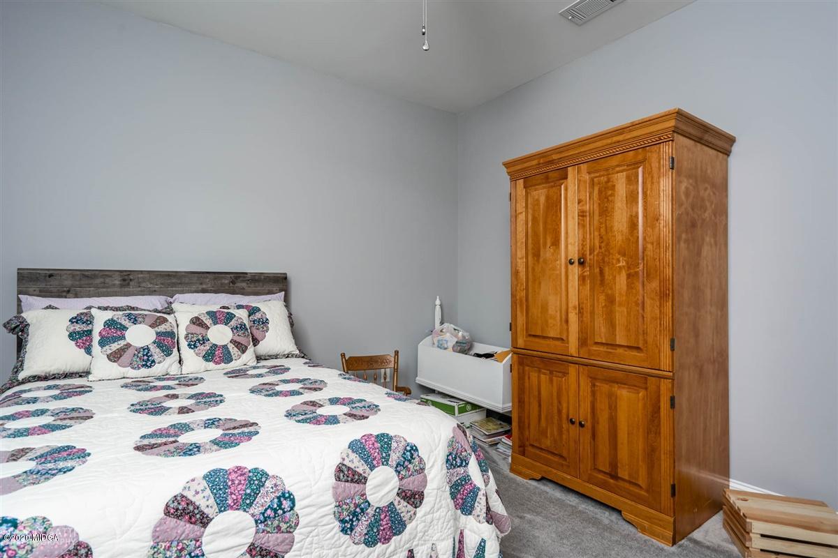 826 Holly Ridge Drive Gray, GA 31032 - Photo 19 of 28 a bedroom with a bed and a dresser