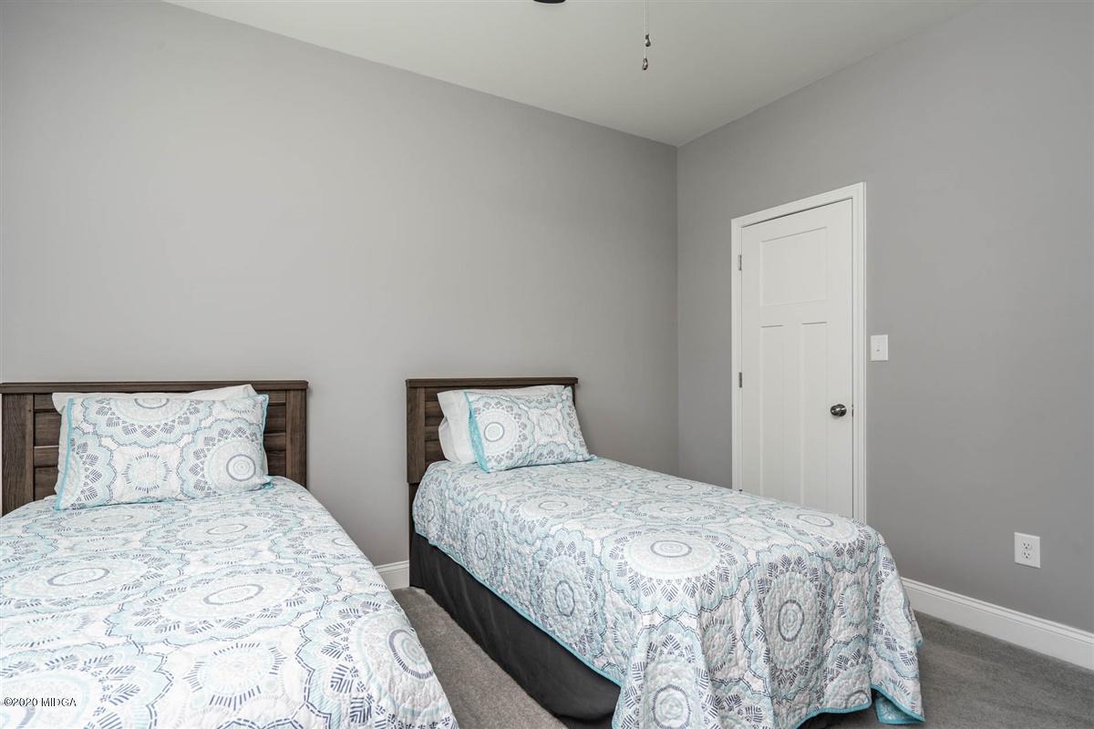 826 Holly Ridge Drive Gray, GA 31032 - Photo 21 of 28 a bedroom with a bed and a night stand