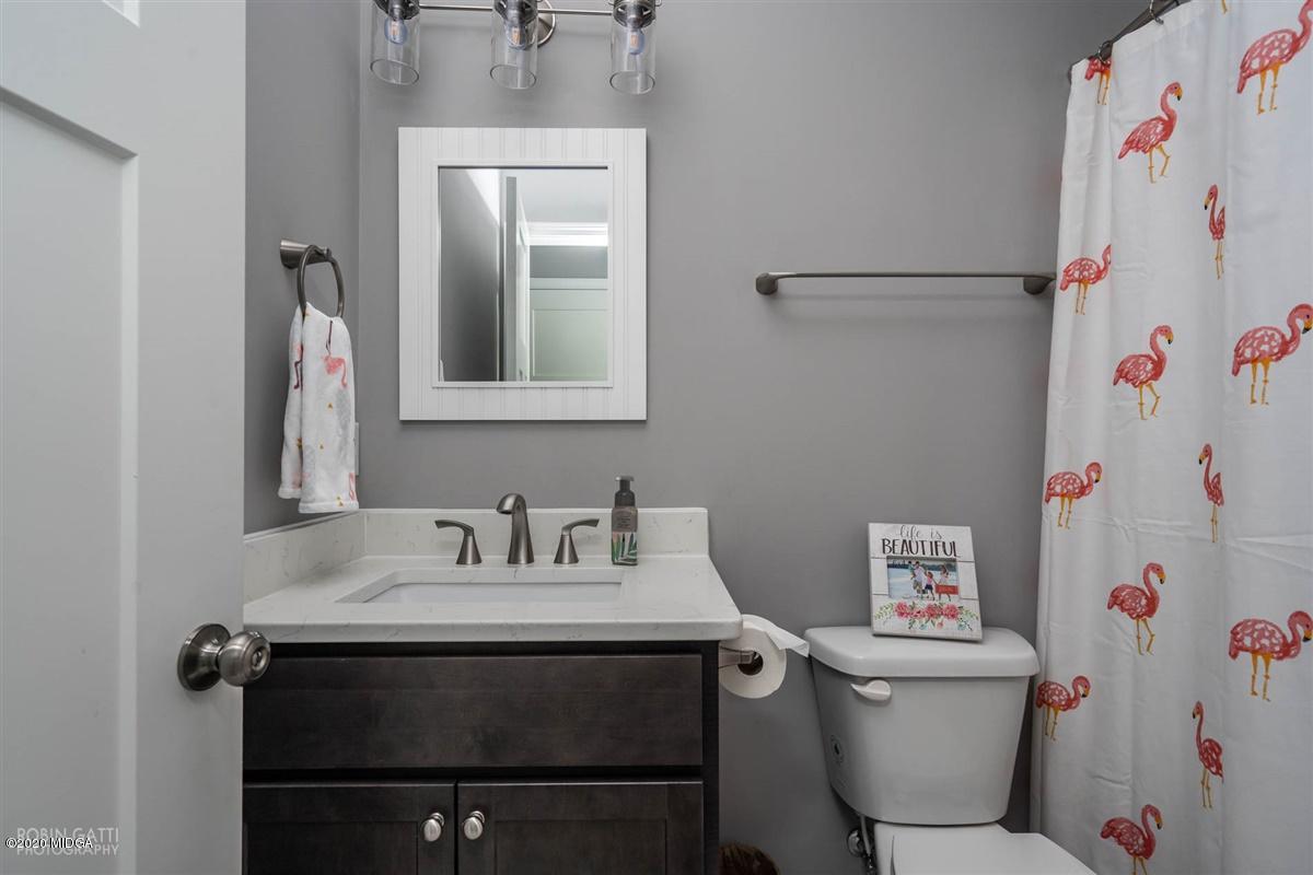 826 Holly Ridge Drive Gray, GA 31032 - Photo 22 of 28 a bathroom with a sink toilet vanity and mirror