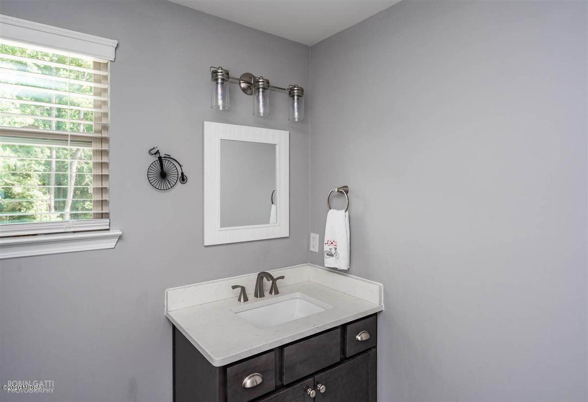 826 Holly Ridge Drive Gray, GA 31032 - Photo 23 of 28 a bathroom with a sink and a mirror