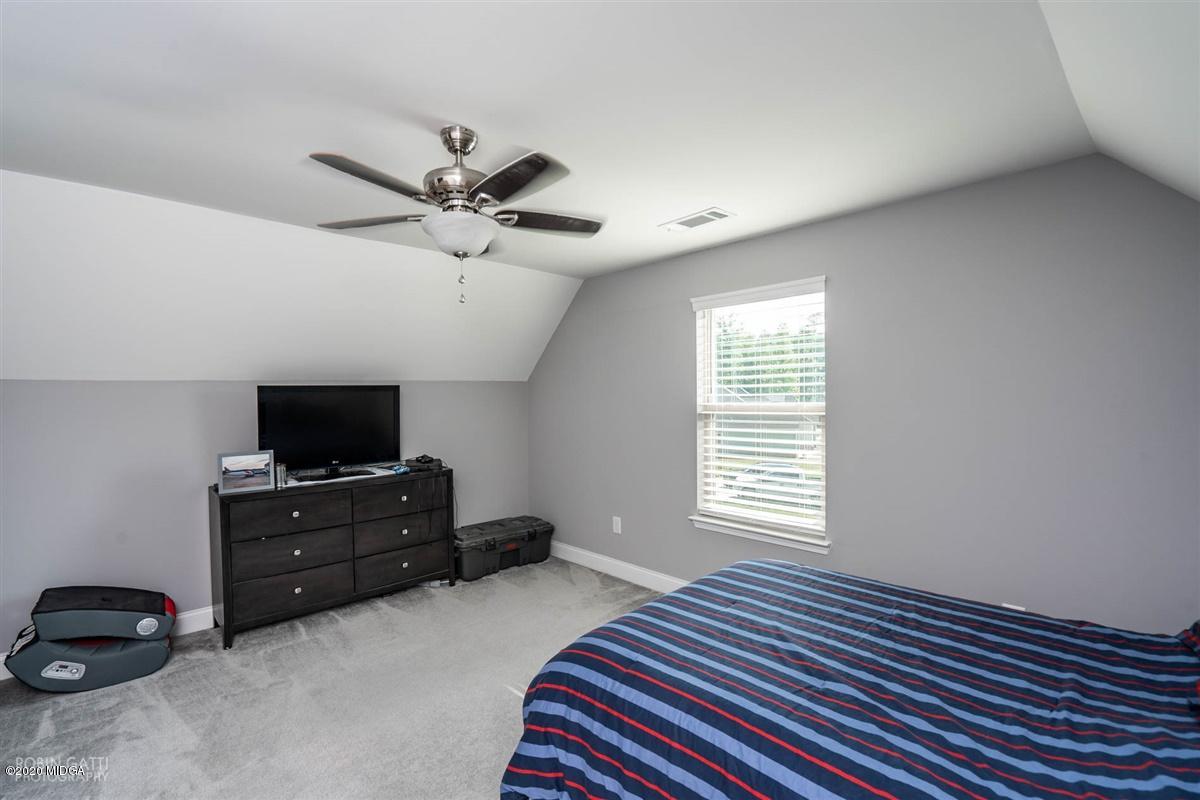 826 Holly Ridge Drive Gray, GA 31032 - Photo 25 of 28 a bedroom with a bed and a flat screen tv