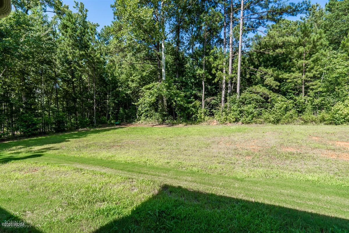 826 Holly Ridge Drive Gray, GA 31032 - Photo 27 of 28 a view of outdoor space with a garden and trees