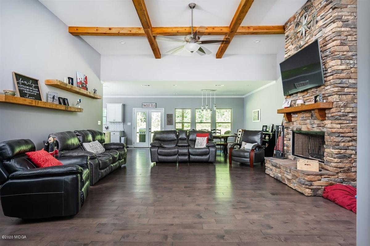 826 Holly Ridge Drive Gray, GA 31032 - Photo 5 of 28 a living room with furniture a flat screen tv and a fireplace