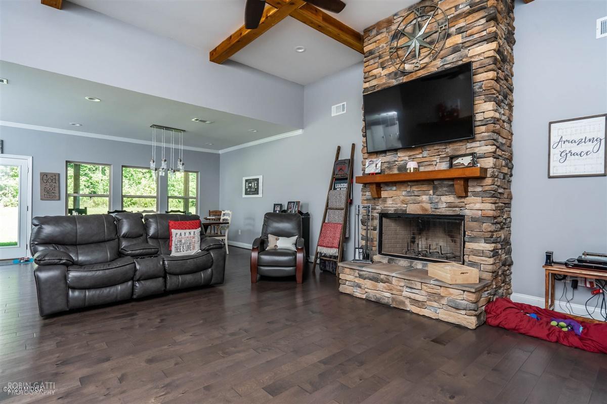 826 Holly Ridge Drive Gray, GA 31032 - Photo 6 of 28 a living room with furniture a flat screen tv and a fireplace