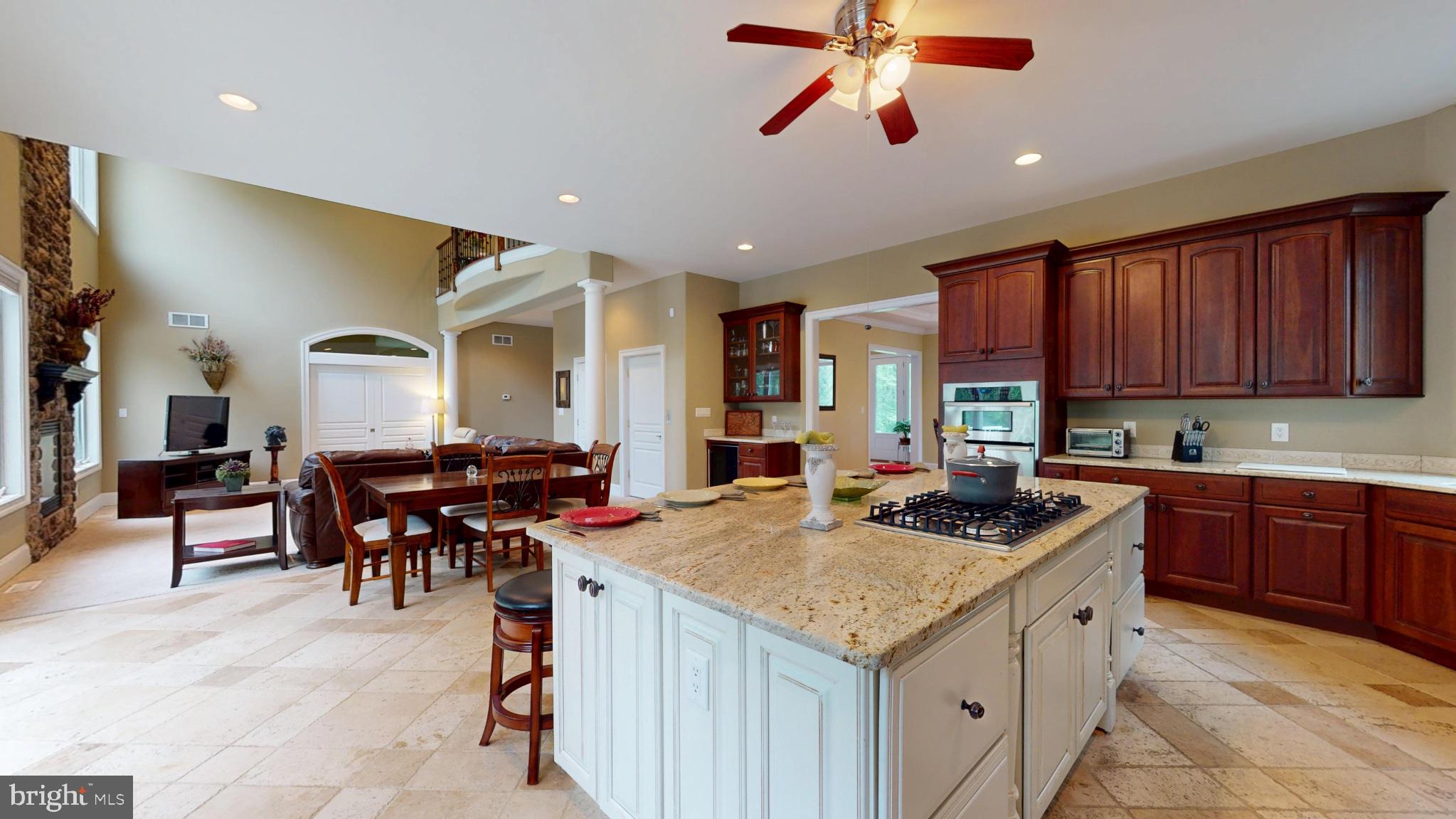 309 Ark Road Mount Laurel, NJ 08054 - Photo 13 of 60 a kitchen with stainless steel appliances granite countertop a stove top oven a sink a dining table and chairs with wooden floor