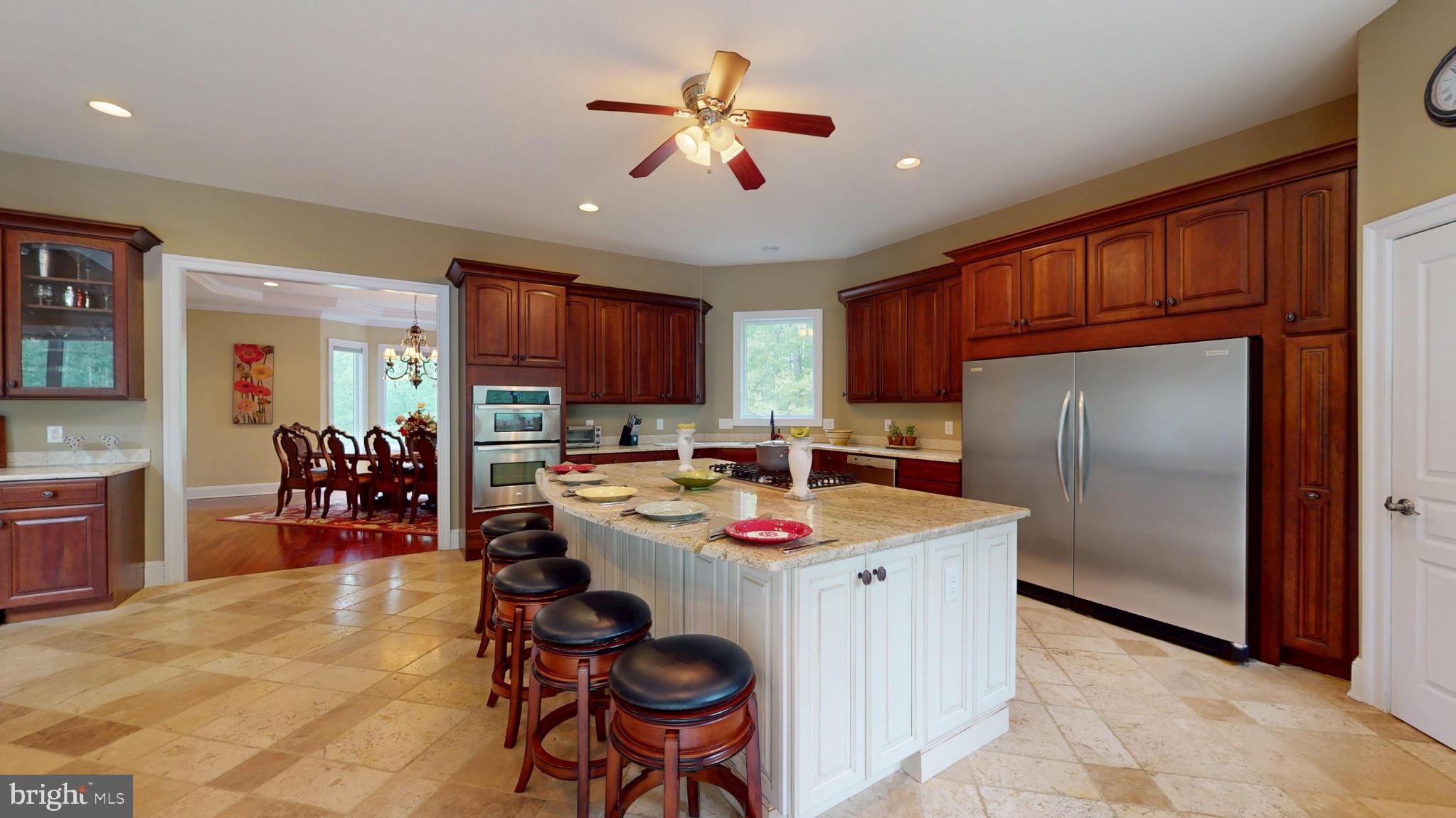 309 Ark Road Mount Laurel, NJ 08054 - Photo 10 of 60 a kitchen with stainless steel appliances granite countertop a refrigerator a sink dishwasher a dining table and chairs with wooden floor