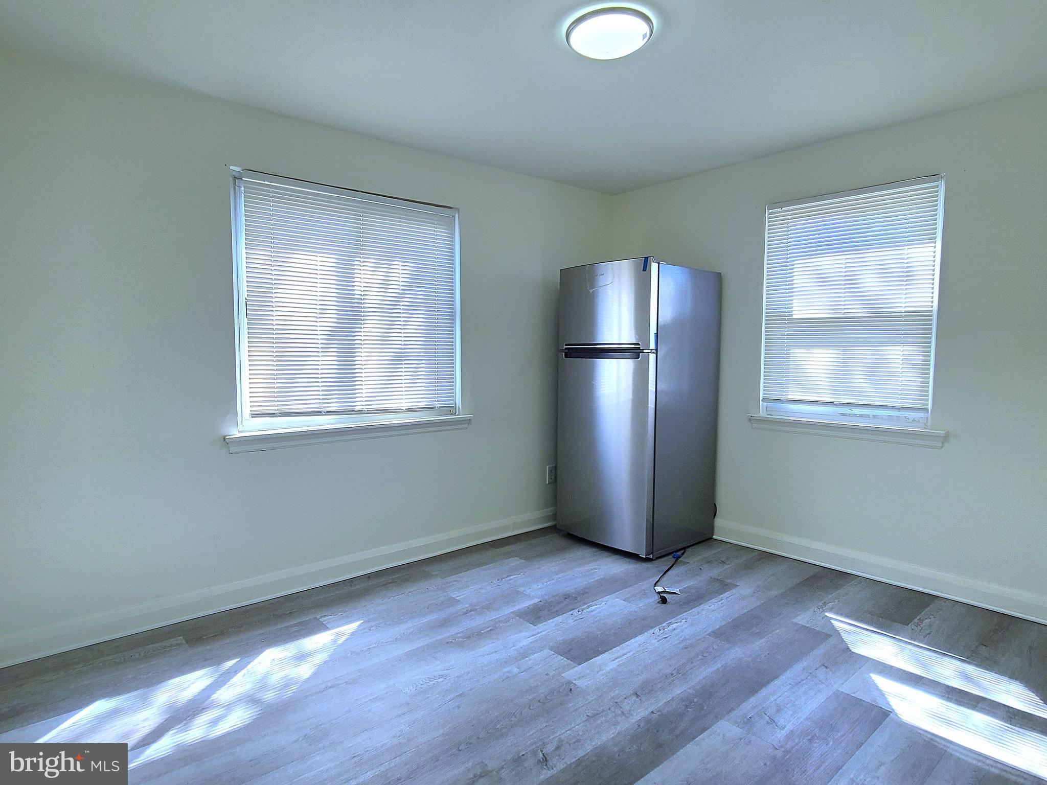 8520 Chestnut Oak Road Parkville, MD 21234 - Photo 11 of 28 a view of an empty room with wooden floor and a window