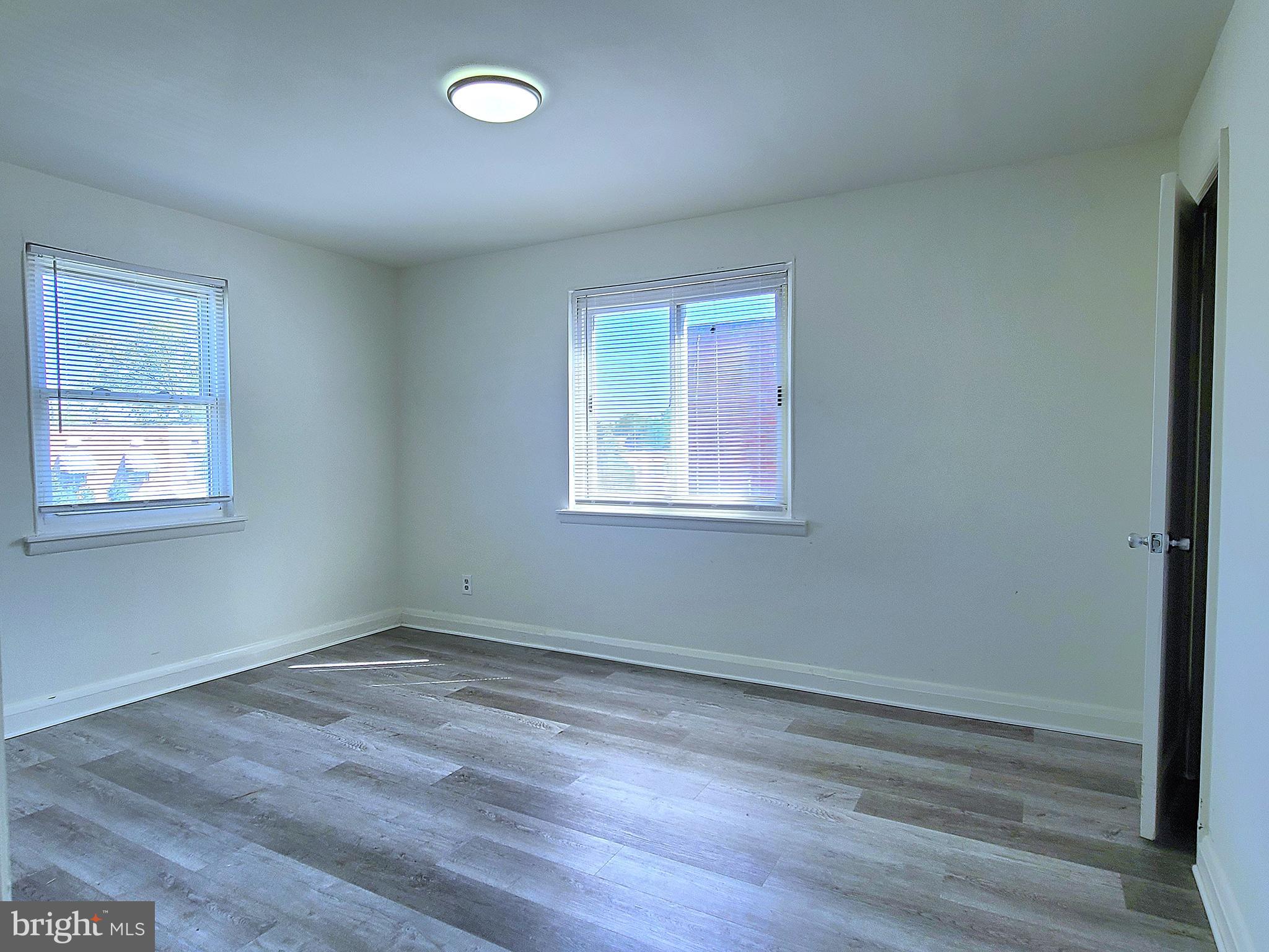 8520 Chestnut Oak Road Parkville, MD 21234 - Photo 13 of 28 a view of a room that has wooden floor and windows in it