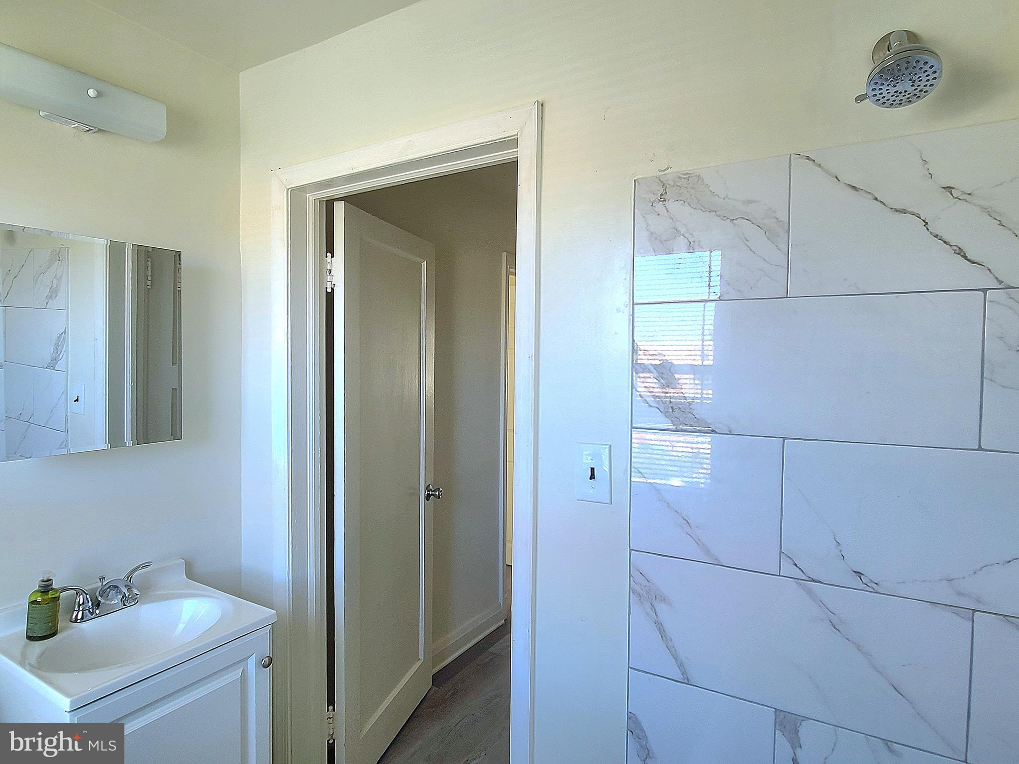 8520 Chestnut Oak Road Parkville, MD 21234 - Photo 14 of 28 a bathroom with a sink and shower